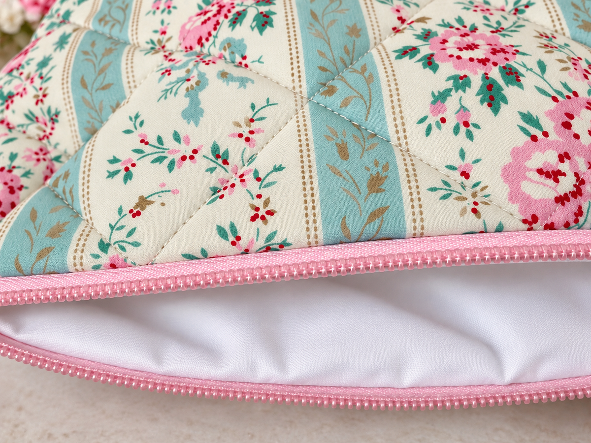 Quilted cosmetic bag with pink roses and blue bows