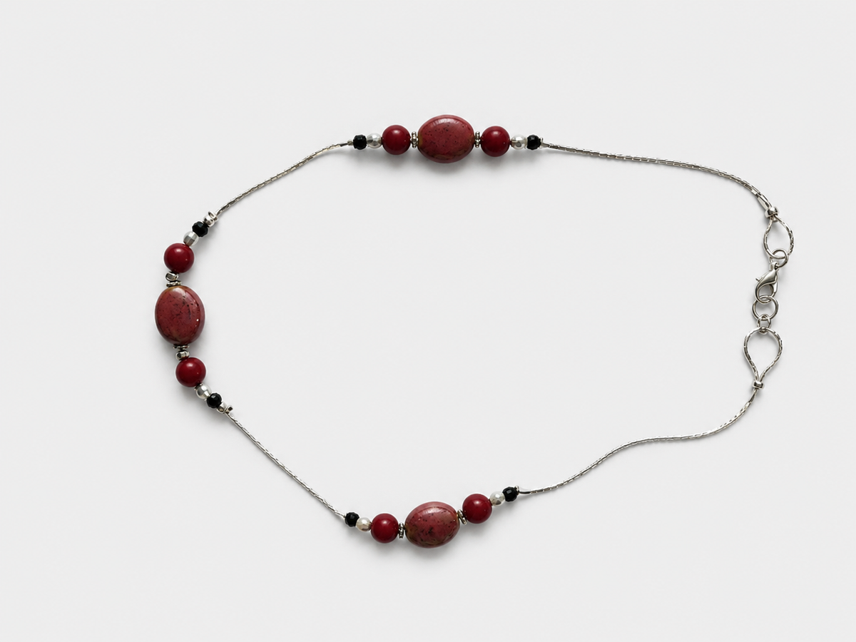 Necklace with draw bench ceramic beads in each station reds and mottled