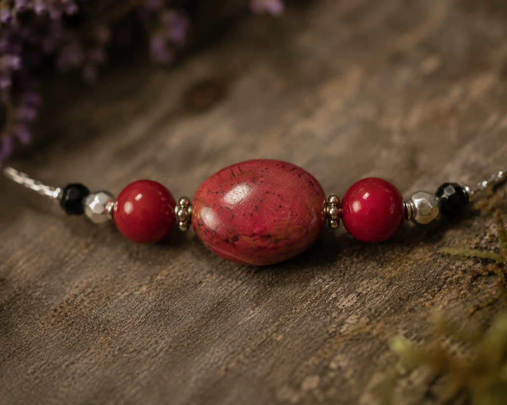 Necklace with draw bench ceramic beads in each station reds and mottled